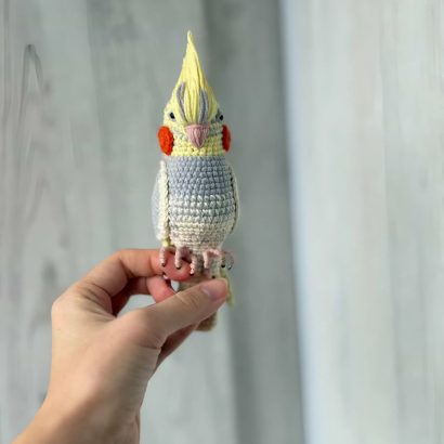 Іграшка в’язаний папуга сувенір в сіро-жовтому кольорі